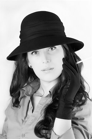 simsearch:400-05693792,k - Portrait of a beautiful brunette young woman with black hat and cigar Stock Photo - Budget Royalty-Free & Subscription, Code: 400-04848201