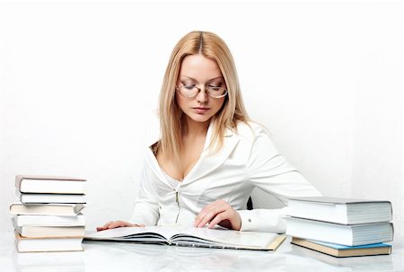 simsearch:400-04860880,k - Young pretty woman learning at table with books over white Stock Photo - Budget Royalty-Free & Subscription, Code: 400-04848581