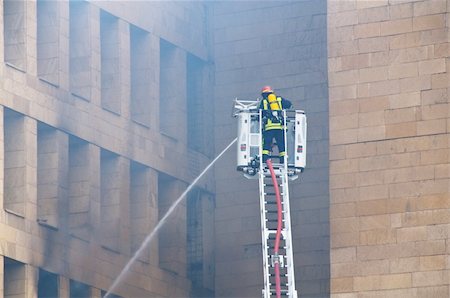 firefighter rescue truck - Firefighter at the fire in the city center Stock Photo - Budget Royalty-Free & Subscription, Code: 400-04840694