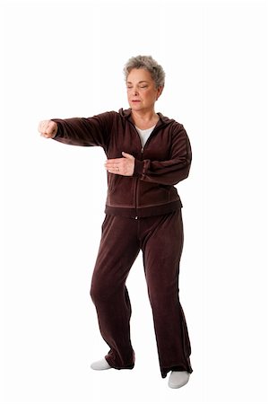 Beautiful Senior woman doing Tai Chi punching exercise to keep her joints flexible, isolated. Stock Photo - Budget Royalty-Free & Subscription, Code: 400-04843440