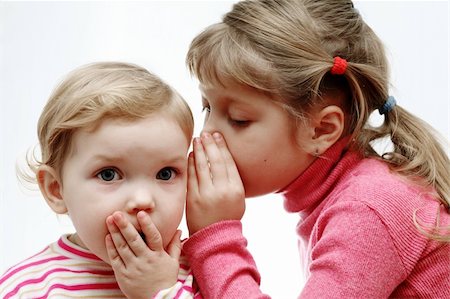 pictures of a little girl whispering - An image of a girl whispering something to a baby Stock Photo - Budget Royalty-Free & Subscription, Code: 400-04850511