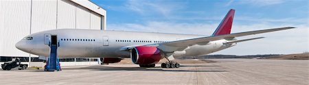 Big passenger  airplane red and white parked near hangar Stock Photo - Budget Royalty-Free & Subscription, Code: 400-04850919