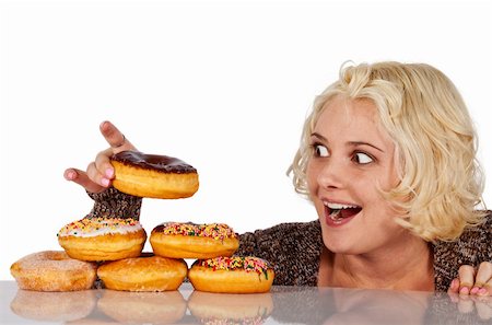 simsearch:400-05106591,k - Woman steal a donut of a pile of donuts Stock Photo - Budget Royalty-Free & Subscription, Code: 400-04852541
