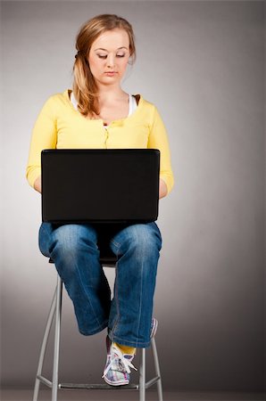 plump girls - young woman is working on laptop sitting on high chair Stock Photo - Budget Royalty-Free & Subscription, Code: 400-04864758