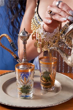 Woman in traditional costume pouring fresh green tea Stock Photo - Budget Royalty-Free & Subscription, Code: 400-04864992