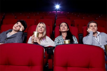 Satisfied girls and bored boys watching a movie at the cinema Stock Photo - Budget Royalty-Free & Subscription, Code: 400-04865873