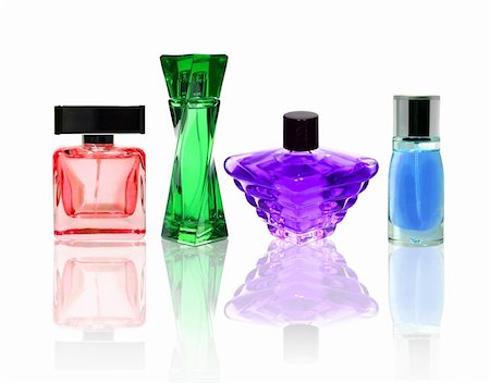 Perfume color glass bottles isolated on white with transparent reflection. Photographie de stock - Aubaine LD & Abonnement, Code: 400-04863535
