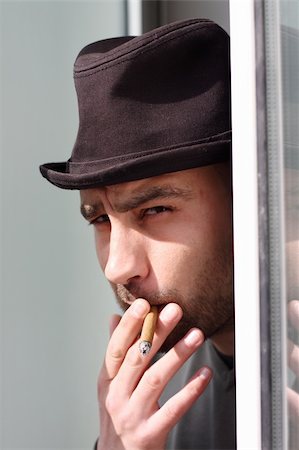 simsearch:400-05207678,k - Portrait of a young man smoking cigar Stock Photo - Budget Royalty-Free & Subscription, Code: 400-04863982