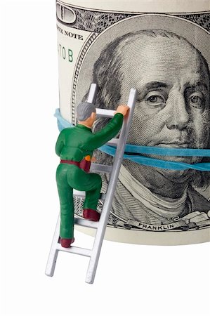 simsearch:400-04529024,k - Miniature man climbing a roll of American money. Stock Photo - Budget Royalty-Free & Subscription, Code: 400-04874148