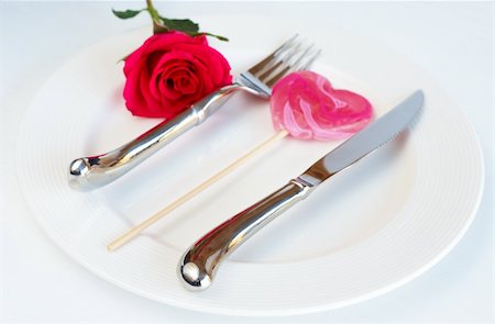 Valentines day table setting with a white plate, single pink rose and heart shaped lolly Stock Photo - Budget Royalty-Free & Subscription, Code: 400-04874656