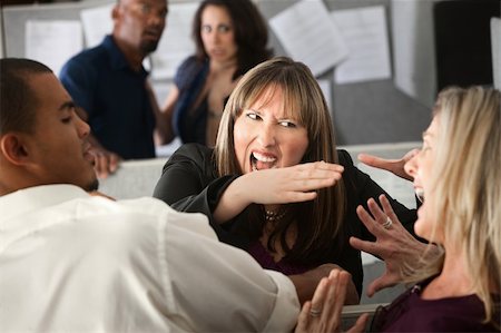 Two woman employees quarreling among other coworkers Stock Photo - Budget Royalty-Free & Subscription, Code: 400-04875757