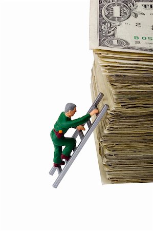 simsearch:400-04529024,k - Miniature man climbing a roll of American money. Stock Photo - Budget Royalty-Free & Subscription, Code: 400-04876437