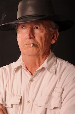 Senior cowboy hat and wearing a smoking a cigarette Stock Photo - Budget Royalty-Free & Subscription, Code: 400-04877195