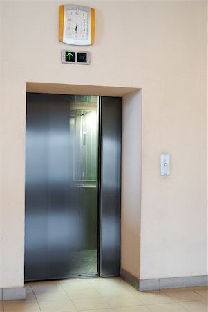 simsearch:400-04333419,k - Blury door movement of the steel lift. 6:30 is on the clock Stock Photo - Budget Royalty-Free & Subscription, Code: 400-04877787