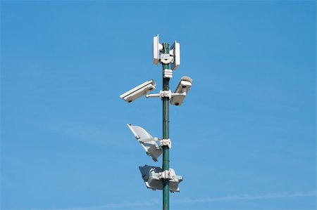 security cameras and floodlights mounted high on a pole to oversee an industrial area Stock Photo - Budget Royalty-Free & Subscription, Code: 400-04878077