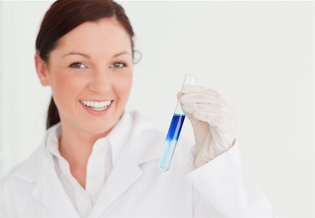 simsearch:400-09011632,k - Smiling scientist looking at the camera while holding a  test tube in a lab Stock Photo - Budget Royalty-Free & Subscription, Code: 400-04879289