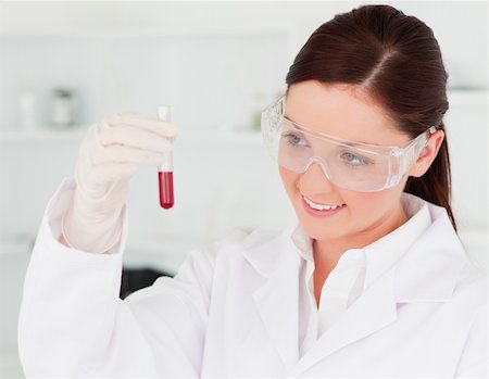 simsearch:400-09011632,k - Pretty scientist looking at a test tube in a lab Stock Photo - Budget Royalty-Free & Subscription, Code: 400-04879282