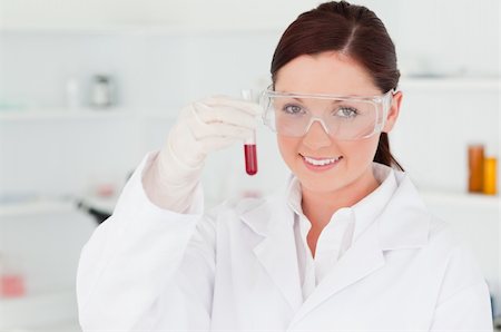 simsearch:400-09011632,k - Gorgeous scientist looking at the camera while holding a  test tube in a lab Stock Photo - Budget Royalty-Free & Subscription, Code: 400-04879283