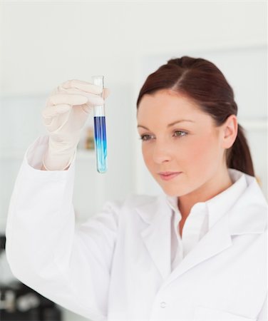 simsearch:400-09011632,k - Beautiful red-haired scientist looking at a test tube in a lab Stock Photo - Budget Royalty-Free & Subscription, Code: 400-04879294