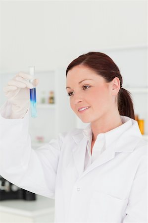 simsearch:400-09011632,k - Attractive red-haired scientist looking at a test tube in a lab Stock Photo - Budget Royalty-Free & Subscription, Code: 400-04879292