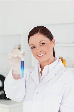 simsearch:400-09011632,k - Good looking red-haired scientist looking at the camera while holding a test tube in a lab Stock Photo - Budget Royalty-Free & Subscription, Code: 400-04879293