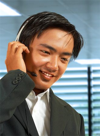 simsearch:400-03933798,k - Male Sales Representative In His Office Talking On A Headset To A Customer Stock Photo - Budget Royalty-Free & Subscription, Code: 400-04871123