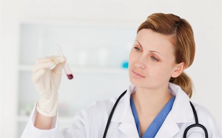 simsearch:400-04881572,k - Female scientist looking at a red test tube in a lab Stock Photo - Budget Royalty-Free & Subscription, Code: 400-04871308