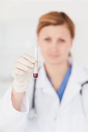 simsearch:400-04881594,k - Female scientist looking at the camera while holding a test tube in a lab Stock Photo - Budget Royalty-Free & Subscription, Code: 400-04871312