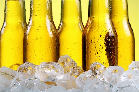 simsearch:400-04083275,k - Bottles of cold and fresh beer with ice over yellow background Stock Photo - Budget Royalty-Free & Subscription, Code: 400-04871882