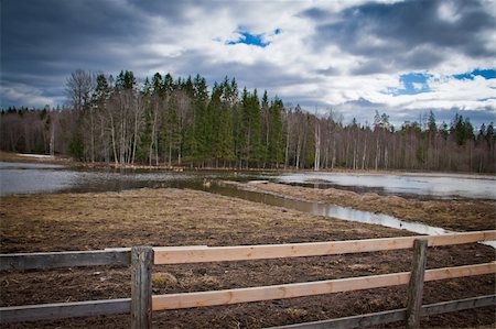 simsearch:400-04909150,k - A field with a wooden fence in the foreground Stock Photo - Budget Royalty-Free & Subscription, Code: 400-04872286