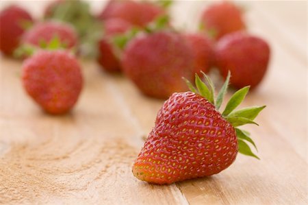 Heap of a lot of fresh red strawberries on wooden table top Stock Photo - Budget Royalty-Free & Subscription, Code: 400-04873594