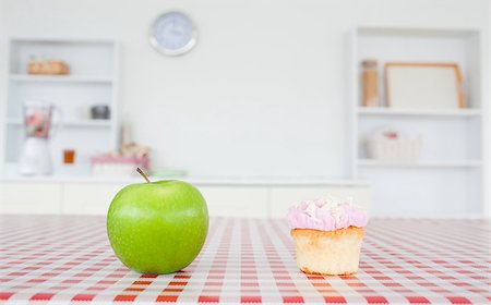 simsearch:400-05106591,k - An apple and a cupcake on a tablecloth in a kitchen Stock Photo - Budget Royalty-Free & Subscription, Code: 400-04884202
