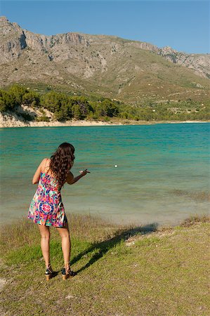 Throwing stones into a scenic mountain lake Stock Photo - Budget Royalty-Free & Subscription, Code: 400-04885832