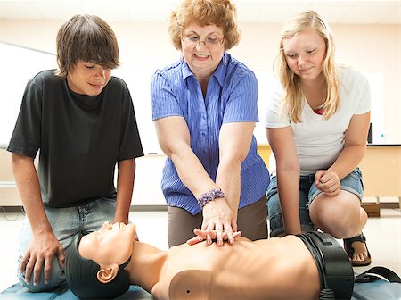 simsearch:400-07411030,k - Teacher demonstrates CPR life saving techniques for her teenage students. Stock Photo - Budget Royalty-Free & Subscription, Code: 400-04886886