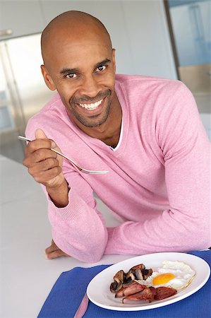 Middle Aged Man Eating Unhealthy Fried Breakfast Foto de stock - Super Valor sin royalties y Suscripción, Código: 400-04888251