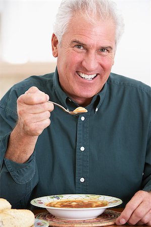 Senior Man Eating Soup, Smiling At The Camera Photographie de stock - Aubaine LD & Abonnement, Code: 400-04888524