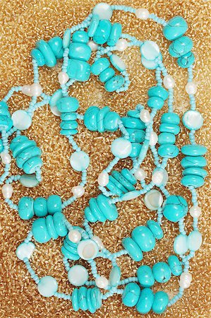 Beads from the turquoise on the golden beads Stock Photo - Budget Royalty-Free & Subscription, Code: 400-04888788
