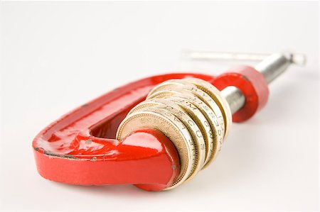 Stack of pound coins in red clamp on white background Stock Photo - Budget Royalty-Free & Subscription, Code: 400-04889630