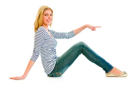 simsearch:400-05888428,k - Smiling beautiful teen girl sitting on floor and pointing finger at something isolated on white Stock Photo - Budget Royalty-Free & Subscription, Code: 400-04880277