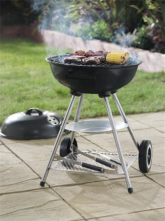 Barbecue in garden setting with food cooking om it Stock Photo - Budget Royalty-Free & Subscription, Code: 400-04880507