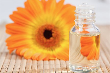 spa water background pictures - Close up on a glass phial and a sunflower Stock Photo - Budget Royalty-Free & Subscription, Code: 400-04881260