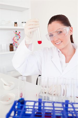 Charming red-haired woman holding a test tube in a lab Stock Photo - Budget Royalty-Free & Subscription, Code: 400-04881585
