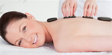 simsearch:400-05352124,k - Smiling woman receiving a hot stone massage Stock Photo - Budget Royalty-Free & Subscription, Code: 400-04881804