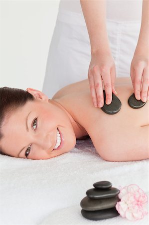 simsearch:400-05352124,k - Smiling young redhead woman having a hot stone massage Stock Photo - Budget Royalty-Free & Subscription, Code: 400-04881810