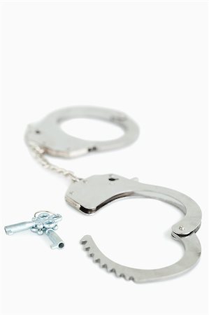 Portrait of handcuffs and keys against a white background Stock Photo - Budget Royalty-Free & Subscription, Code: 400-04882277