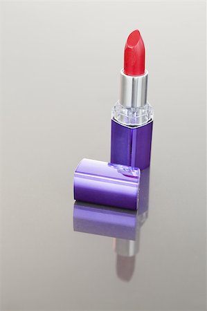 simsearch:400-05708035,k - Portrait of a red lipstick with a purple tube against a white background Stock Photo - Budget Royalty-Free & Subscription, Code: 400-04882296