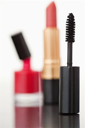 simsearch:400-05708035,k - A mascara tube with a lipstick and a nail polish flask with the camera focus on the mascara Stock Photo - Budget Royalty-Free & Subscription, Code: 400-04882290