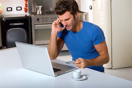 man in the kitchen with laptop Stock Photo - Budget Royalty-Free & Subscription, Code: 400-04882551