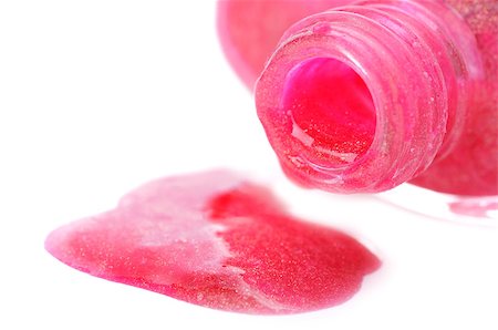 Close-up of open nail polish bottle and poured rose polish on white background. Shallow depth of fields. Focus on bottleneck. Stock Photo - Budget Royalty-Free & Subscription, Code: 400-04882762