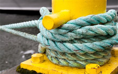 simsearch:400-04433053,k - Twisted green rope around a yellow pier Stock Photo - Budget Royalty-Free & Subscription, Code: 400-04883499
